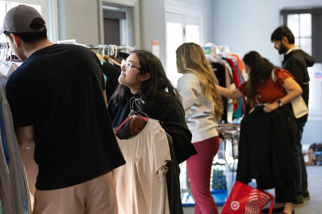 Image of students browsing the clothing options at UNO Career Closet